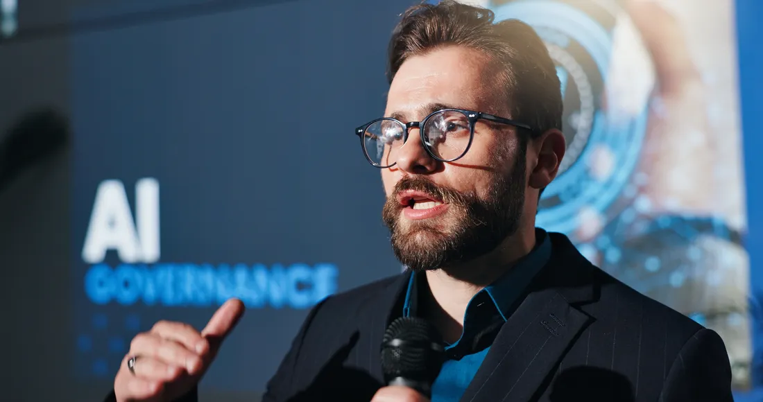A speaker presenting on AI governance