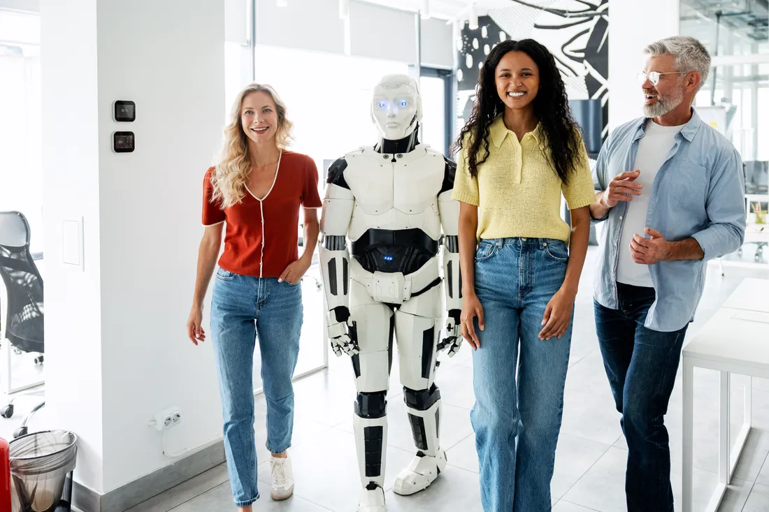A team walking alongside a humanoid robot